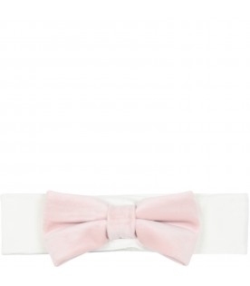 White headband decorated with pink velvet bow on the front.